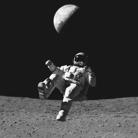 An astronaut leaping across the surface of the Moon, with the Earth above