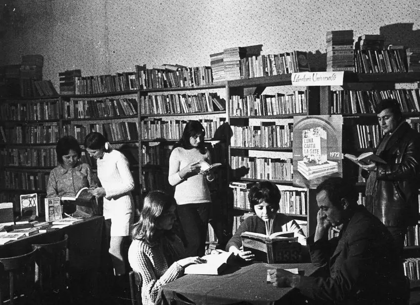 Readers browsing the shelves of a crowded library
